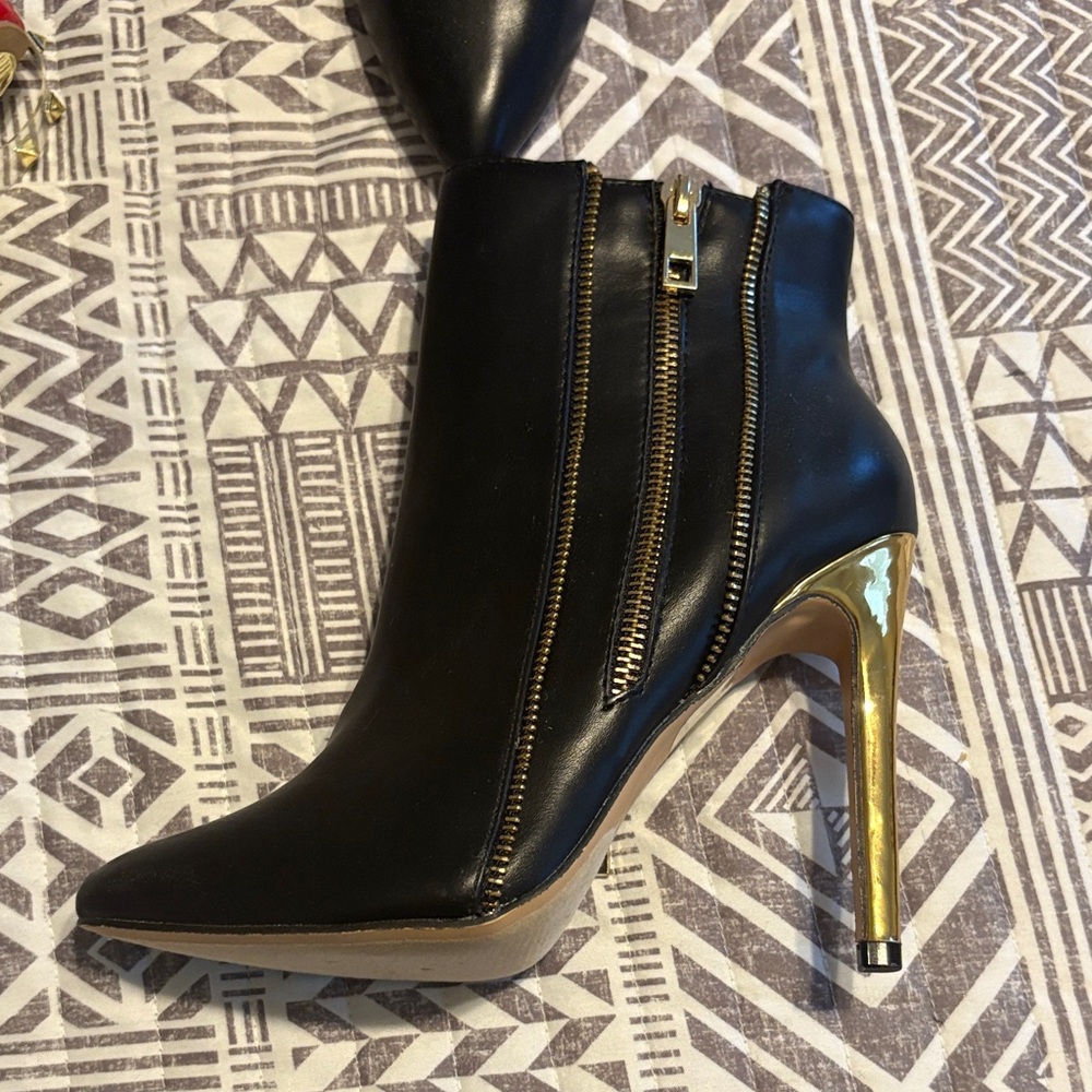Sleek Black and Gold Heeled Boots